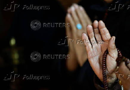 Tibetans in Nepal offer prayers at a monastery in memory of those killed in the recent earthquake, at the Tibetan Refugee Camp in Lalitpur