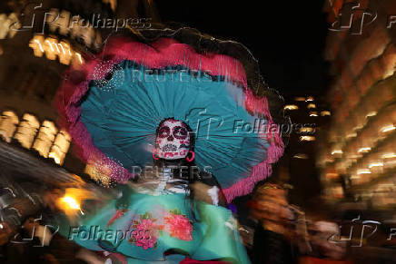 A woman in costume poses for a photo during the annual NYC Halloween Parade in Manhattan in New York