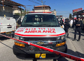 Israeli security and rescue personnel at the scene of a shooting attack on a car and bus where at least three Israelis were killed near Kedumim in the Israeli-occupied West Bank