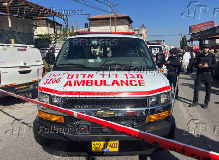 Israeli security and rescue personnel at the scene of a shooting attack on a car and bus where at least three Israelis were killed near Kedumim in the Israeli-occupied West Bank