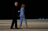 U.S. President Joe Biden and First Lady Jill Biden walk to board an airplane to depart Dobbins Air Reserve Base in Marietta