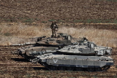 Israeli army soldiers and tanks gather in northern Israel