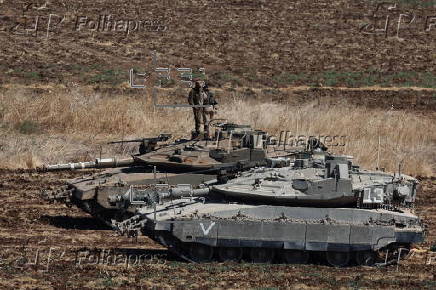 Israeli army soldiers and tanks gather in northern Israel