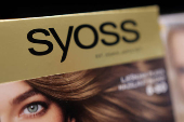 A Syoss product is displayed on a shelf in a supermarket