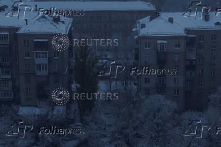 A window is illuminated in a residential building during power outages in Kyiv