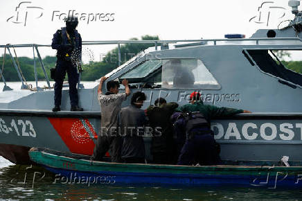 Members of Ecuador's Navy carry out a river patrol, Guayaquil
