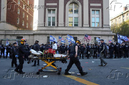 People carry American and Israeli flags as they demonstrate outside the Columbia University campus