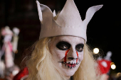 A woman in costume poses for a photo during the annual NYC Halloween Parade in Manhattan in New York