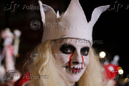 A woman in costume poses for a photo during the annual NYC Halloween Parade in Manhattan in New York