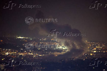 Smoke billows over Beirut's southern suburbs after a strike, amid ongoing hostilities between Hezbollah and Israeli forces