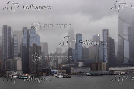 Clouds are pictured over the skyline of New York during a rainy day as it is seen from Weehawken, New Jersey