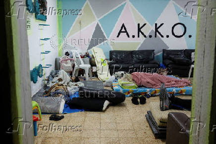 Israelis gather at a bomb shelter following rocket attacks from Lebanon towards Israel, in Acre