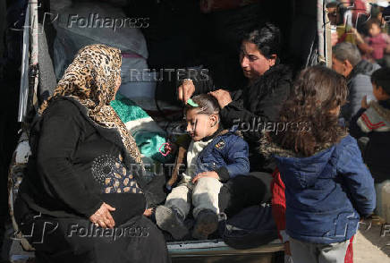 Displaced woman who fled Aleppo countryside, combs a girl's hair in Tabqa