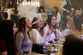 People gather on Christmas day at a restaurant in Damascus