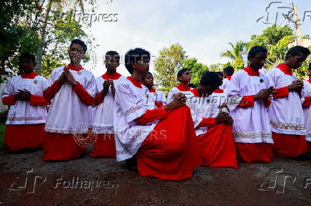 Altar boys pray during the Holy Friday Passion of the Lord Celebrations at a church in Colombo