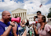 FILE PHOTO: Abortion rights activists and counter protesters protest outside the U.S. Supreme Court, in Washington