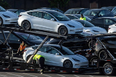 FILE PHOTO: Tesla Model 3 vehicles are seen for sale at a Tesla facility in Fremont, California