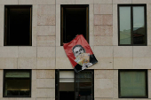 Far-right political party Chega expose banners on the facade of the Portuguese parliament against the wage reinstatement for politicians after the cuts imposed by the Troika, during the debate and vote of the 2025 budget bill on final reading, in Lisbon