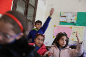 Students in a classroom after authorities announced the reopening of schools, in Damascus