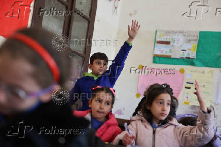 Students in a classroom after authorities announced the reopening of schools, in Damascus