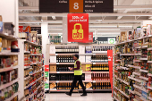 FILE PHOTO: A employee walks inside a Sainsbury?s supermarket in Richmond, west London