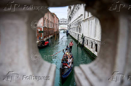 A gondolier rows his gondola through the Venice Canal ahead of Pope Francis's visit, in Venice