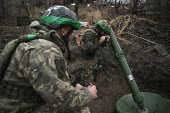 Policemen of the 'Khyzhak' Brigade prepare to fire a mortar towards Russian troops at their position in a front line near the town of Toretsk