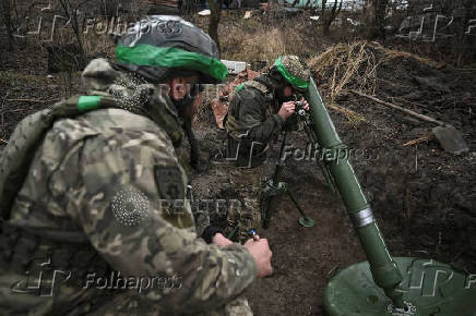 Policemen of the 'Khyzhak' Brigade prepare to fire a mortar towards Russian troops at their position in a front line near the town of Toretsk