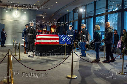 Mourners view the casket of former President Jimmy Carter as he lies in repose at the Carter Presidential Center in Atlanta