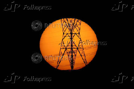 FILE PHOTO: Pylons of high-tension electricity power lines are seen during sunset in Brasilia