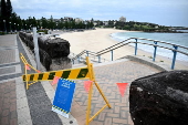 Tar balls washed ashore forces closure of Coogee Beach