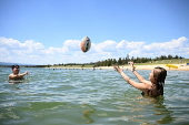 People find relief from the summer heat at Penrith Beach in Australia