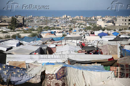 Palestinians wait to collect water in Khan Younis