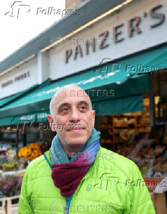 Josephs, owner of Panzer's, poses outside delicatessen in London