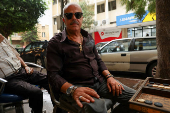 Joseph Ghafary, a state employee, poses as he plays backgammon in Ashrafieh