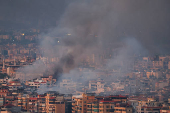 Smoke billows over Beirut's southern suburbs, as seen from Sin El Fil