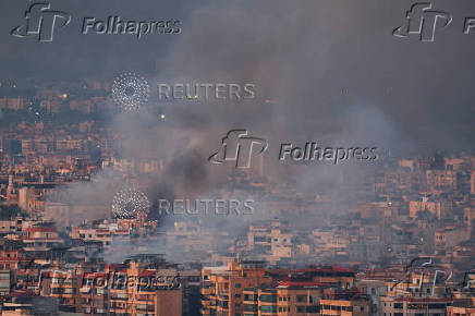 Smoke billows over Beirut's southern suburbs, as seen from Sin El Fil