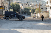 Palestinian security forces patrol amid clashes with militants at the camp in Jenin