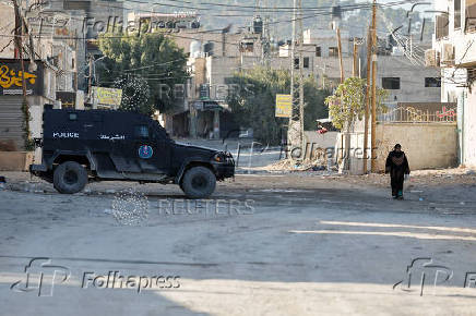 Palestinian security forces patrol amid clashes with militants at the camp in Jenin