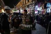 Abu Mohamed, a tamarind juice seller, poses for a photograph at the old city, in Damascus