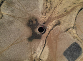 A drone view of a woman drawing water from a parched well in Kasara