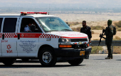 An Israeli policeman and soldier patrol the area near Allenby Bridge Crossing between the West Bank and Jordan following a shooting incident at the crossing in the Israeli-occupied West Bank