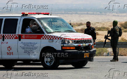 An Israeli policeman and soldier patrol the area near Allenby Bridge Crossing between the West Bank and Jordan following a shooting incident at the crossing in the Israeli-occupied West Bank