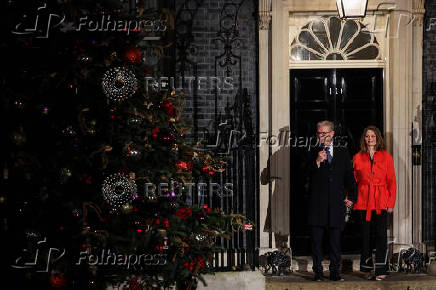 British Prime Minister Starmer and his wife switch on the Downing Street Christmas tree lights, in London