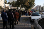 Former members of Syria's Bashar Al Assad's security forces wait to register for the identification and reconciliation process, in Damascus