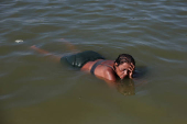 A woman cools off at the artificial pond known as Piscinao de Ramos in Rio de Janeiro