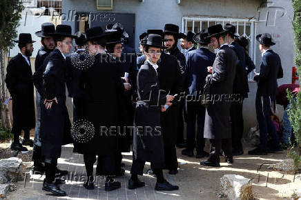 Ultra-Orthodox Jews line up at an Israeli draft office to process their exemptions from mandatory military service at a recruitment base in Kiryat Ono