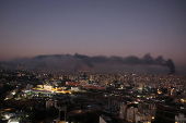 Smoke billows over Beirut's southern suburbs, as seen from Sin El Fil