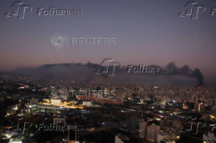 Smoke billows over Beirut's southern suburbs, as seen from Sin El Fil