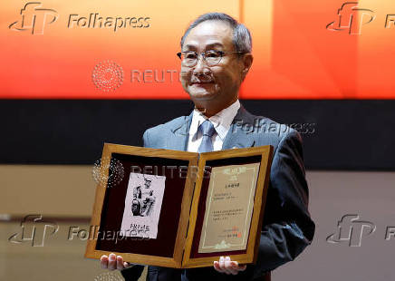 Akiyoshi Yamamura, President of Tokyo Metro, holds an IPO certificate at a ceremony to mark the company's debut on the Tokyo Stock Exchange in Tokyo